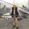 Tiny guy stands on platform
