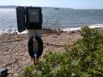 Tide Gauge with Black Rock in Background